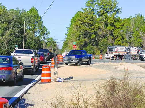 Crews direct traffic Friday as the opening of a portion of the new Dunns Creek Bridge causes traffic jams along detour routes.