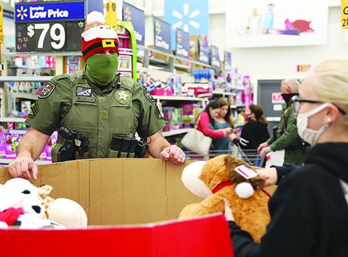 A deputy discusses a purchase while taking local kids shopping on Sunday.