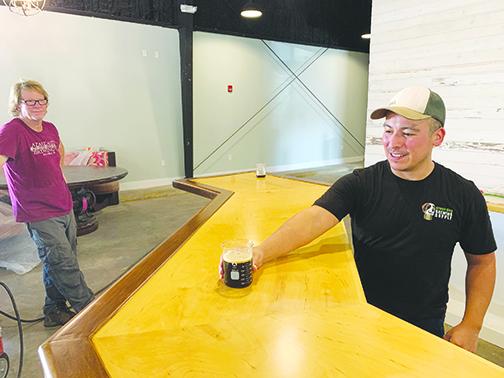 Azalea Brewing Co. head brewer Eli Miranda pours a beer in October when the Palatka brewery was almost completed. 