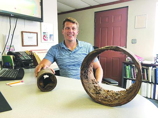 Palatka General Services Director Jonathan Griffith displays a piece of cast iron pipe that dates back to 1886 in his office.