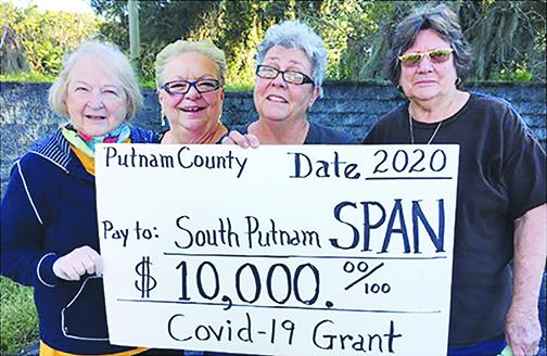 South Putnam Animal Network board members, from left, Alice McCoy, Chris Peterson, Diane Sykes and Linda Young hold a ceremonial check in honor of their CARES Act grant.