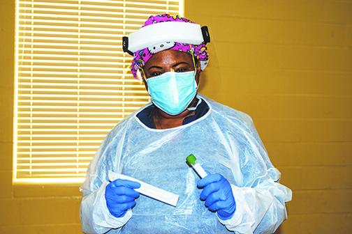 A health worker prepares to conduct a COVID-19 test at the county’s testing facility, 1101 Husson Ave. in Palatka, which is open Monday through Friday, except for New Year’s Eve and New Year’s Day.