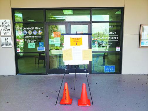 Signs on the front doors of the Putnam County Government Complex in March inform would-be visitors of new procedures, including a statewide and countywide state of emergency, to prevent the spread of coronavirus. 