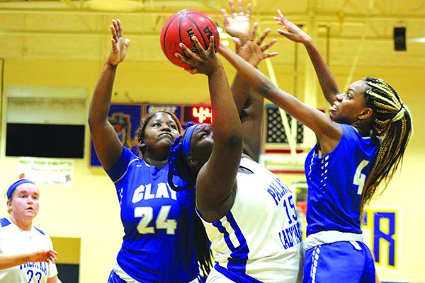 Palatka’s Torryance Poole goes up for a shot against Clay’s Mackenzie White (24) and Jaida Griner in Thursday night’s game. (MARK BLUMENTHAL / Palatka Daily News)