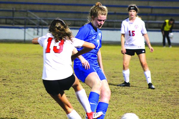 Palatka’s Mattie Smith tries to get the ball away, while being defended by Baker County’s Savannah Pelfrey during Friday night’s game at Cooper-Bennett Field at Veterans Stadium. (MARK BLUMENTHAL / Palatka Daily News)