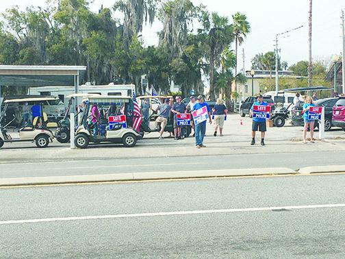 Crescent City residents stand on Summit Street to advocate for the police department’s return during the Rally to Save Crescent City Police on Saturday afternoon.