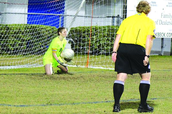 Palatka High starting goalkeeper Christina Bayse goes down to stop a penalty kick by Crescent City’s Diana Quintana in the first half. (MARK BLUMENTHAL / Palatka Daily News)