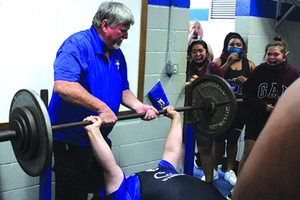 With head coach Ron Whitehurst grabbing the bar to put it back, Interlachen High weightlifter Marissa McKibben completes her 200-pound bench press in the unlimited weight class on Wednesday. (MARK BLUMENTHAL / Palatka Daily News)
