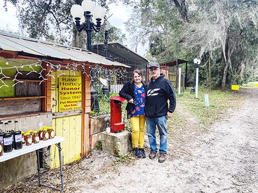 Scott and Elaine McMillin, owners of The Honey Stand in San Mateo, stand next to the roadside business, which has been a local favorite for years.
