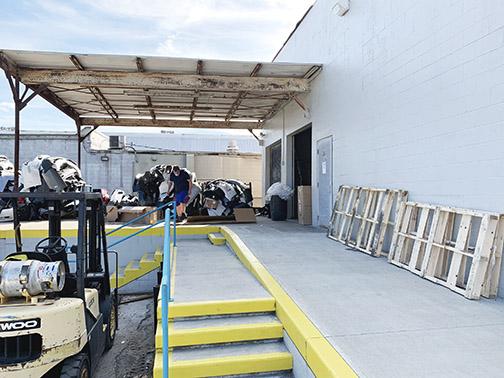 An employee breaks down a box at Beck Automotive Group’s wholesale parts facility, which will be revamped as part of a $3.5 million overhaul.