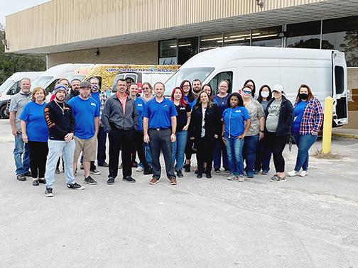 Employees of Beck Automotive Group’s wholesale parts operation gather in front of the Reid Street building in Palatka the company purchased because of its expanding business.