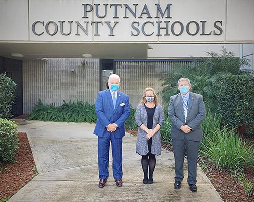 From left, U.S. Department of Agriculture Rural Development state Director Phil Leary, Putnam County School District Director of Federal Programs Mellissa Coleman and Superintendent Rick Surrency stand outside of district headquarters.