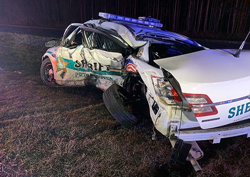 A Putnam County Sheriff’s Office patrol vehicle with extensive damage to its driver side sits on the side of State Road 20 Tuesday night after being involved in a crash. 