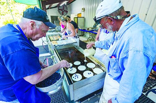 Volunteers make blueberry pancakes for the popular pancake-and-sausage breakfast at the 2019 Bostwick Blueberry Festival.