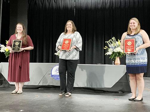 From left, Palatka High teacher Alexis Strickland-Tilton, district executive secretary Jackie Smith and Mellon Elementary student-teacher Jennifer Rawski hold their plaques after being named Teacher of the Year, District-Related Employee of the Year and School-Related Employee of the Year, respectively, on Tuesday night.