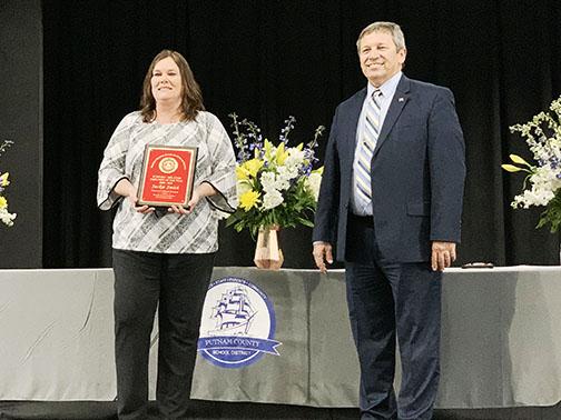 School district executive secretary Jackie Smith stands with Surrency after being named District-Related Employee of the Year on Tuesday night.