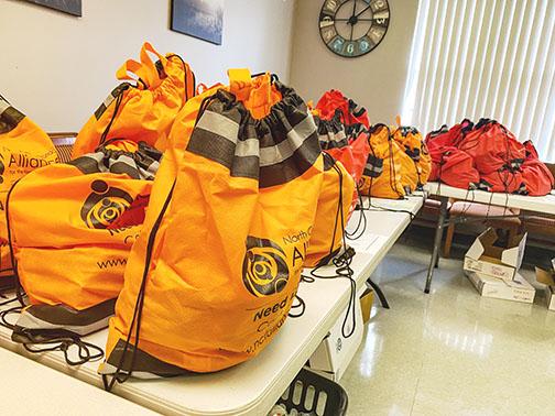 Bags to be distributed to homeless Putnam County residents sit on a table at SMA Healthcare in Palatka on Wednesday.