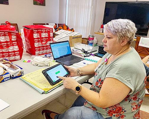 Point in Time Team lead Lori Shaw shows how volunteers register homeless residents in Putnam County on Wednesday.