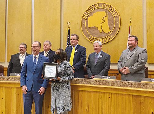 Victoria McRae, an employee at the Putnam County Property Appraiser’s Office, stands with county officials as she is recognized for her five years of service to the community during Tuesday morning’s Board of County Commissioners meeting.