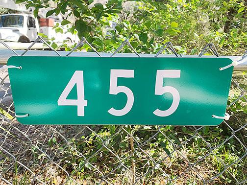A green, reflective address sign tells Putnam County Emergency Services first responders where to go in case of an incident.