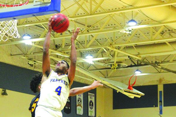 Palatka’s Jimmy Williams goes up for a shot against West Nassau’s Simeon Womock during Friday night’s game won by the visiting Warriors, 71-62. (MARK BLUMENTHAL / Palatka Daily News)