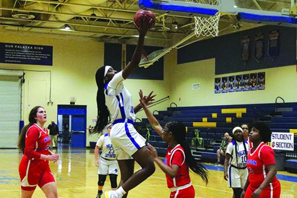 Palatka’s Amareya Turner drives to the basket for a layup attempt against Jacksonville Wolfson’s Raelyn Smith in the first half of Monday night’s District 4-4A tournament opener. (ANTHONY RICHARDS / Palatka Daily News)