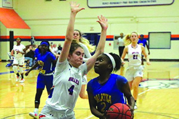 Palatka’s Zyria Jones drives to the basket against Bolles School’s Ella Stakem during Wednesday night’s District 4-4A tournament semifinal. (ANTHONY RICHARDS / Palatka Daily News)