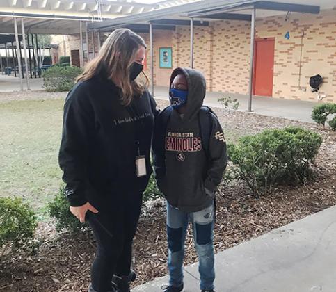 Putnam County School District’s School-Related Employee of the Year, Jennifer Rawski, greets a student early Thursday morning at Mellon Elementary School.