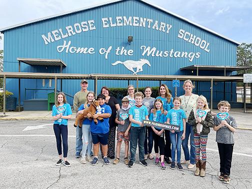 Melrose Elementary School students and parents stand in front of the school Tuesday afternoon.