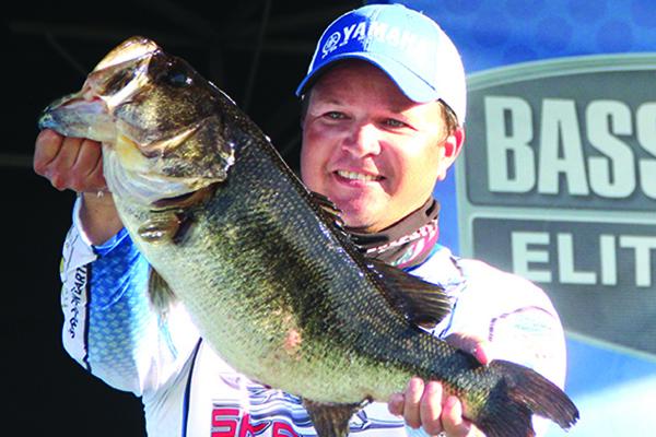 Derek Hudnall shows off the biggest bass catch of the day on the stage as part of his second-place start. (ANTHONY RICHARDS / Palatka Daily News)