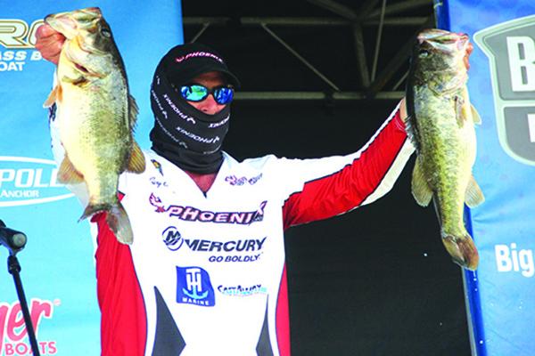 First-day leader Gary Clouse shows off some of his catches to the crowd. (ANTHONY RICHARDS / Palatka Daily News)