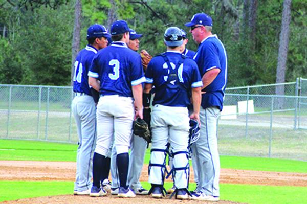 St. Johns River State College baseball coach Ross Jones (right) talks with starting pitcher Jason Gonzalez (middle) during Friday’s game against Pensacola State. (ANTHONY RICHARDS / Palatka Daily News)