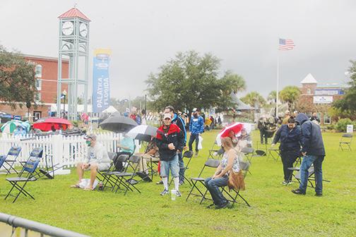 Bassmaster Elite Series fans get drenched in the storm as they await the weigh-in ceremony Sunday, the final day of the tournament.