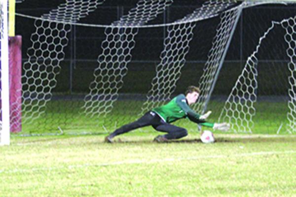 Jacksonville Episcopal goalie Mike Mumford makes the diving save on Crescent City's Esquiel Vences to secure the Eagles’ victory. (MARK BLUMENTHAL / Palatka Daily News)