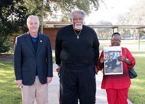 From left, St. Johns River State College President Joe Pickens, Horace Sermon and Georgia Mae McRae, widow of Earnest McRae, stand in front of the college to talk about the McRae-Sermon Scholarship.