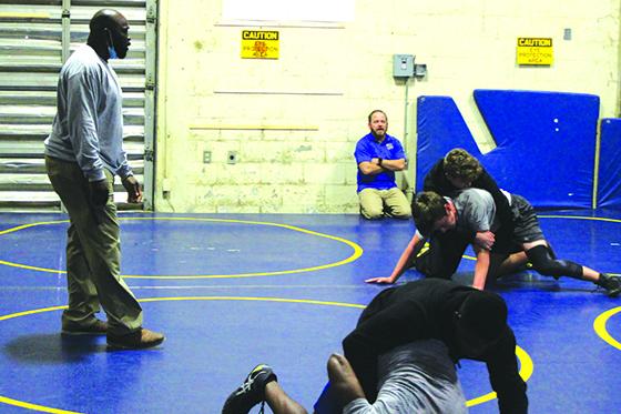 Assistant coach Elijah Campbell (left) and head coach Josh White (in back) watch Palatka High wrestlers go through wrestling battles in practice on Tuesday. (MARK BLUMENTHAL / Palatka Daily News)