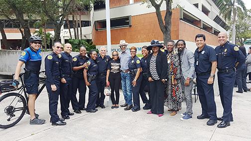 Clarence Dickson, the first Black Miami Police Department chief, gathers with family, friends and more recent members of the department. 
