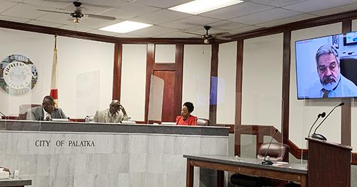 Palatka City Manager Don Holmes, on-screen at right, discusses personnel matters with city commissioners at Thursday night’s commission meeting.