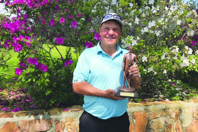 Randy Haag shows off the trophy he won at the Senior Azalea Golf Tournament last year. (Daily News file photo)