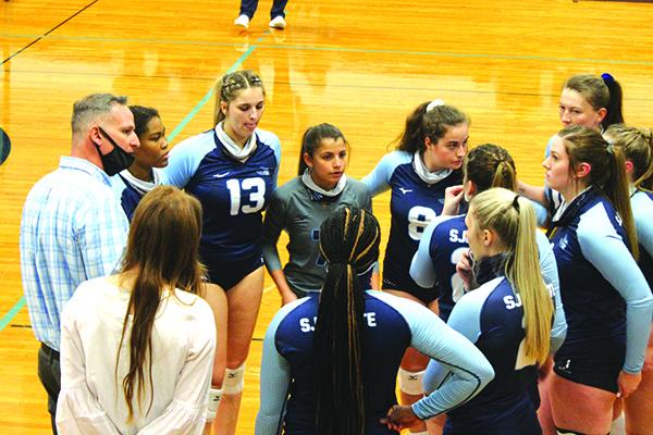 St. Johns River State College volleyball coach Matt Cohen (at left) talks to his players during a timeout Wednesday night. (MARK BLUMENTHAL / Palatka Daily News)