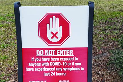 A Bassmaster sign at the Palatka Riverfront informs visitors not to enter if they’ve been exposed to anyone with COVID-19 or experienced any symptoms.