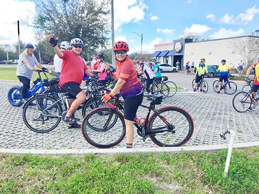 North Florida Bicycle Club riders smile Sunday as they stop for a break outside of Burger King in East Palatka.