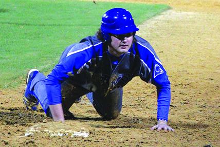Interlachen’s Nathan Bass slides back into first base after a pickoff attempt. The throw sailed away and allowed Bass to get up and advance to second base. (ANTHONY RICHARDS / Palatka Daily News)