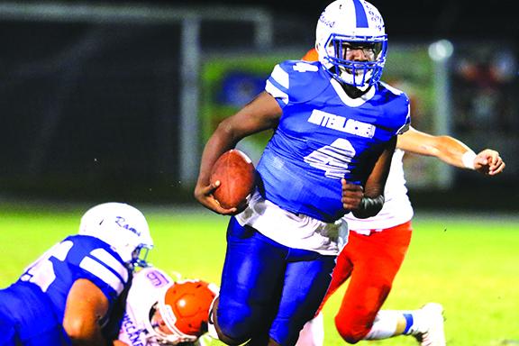 Interlachen High School football quarterback Reggie Allen Jr. scrambles for yards during a 2020 game. The Rams will remain in Region 1-3A next season. (GREG OYSTER / Special to the Daily News)