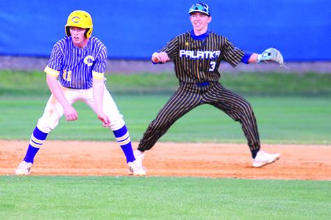 Palatka shortstop Hunter Keen sneaks in behind Lake City Columbia runner Ty Wehinger during Friday’s night game at the Azalea Bowl. (ANTHONY RICHARDS / Palatka Daily News)