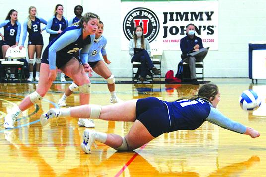 St. Johns River State College’s Tara English dives for a ball to keep possession alive during the second set of Thursday’s match against host Lake-Sumter. Emily Evans (21) and Dariana Luna (3) look on. (ANTHONY RICHARDS / Palatka Daily News)