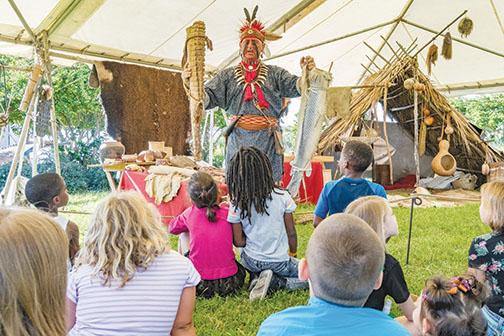 Jim Sawgrass of the Florida Muskogee Creek Tribe acts as The Long Warrior to educate schoolchildren during the 2019 Bartram Frolic.