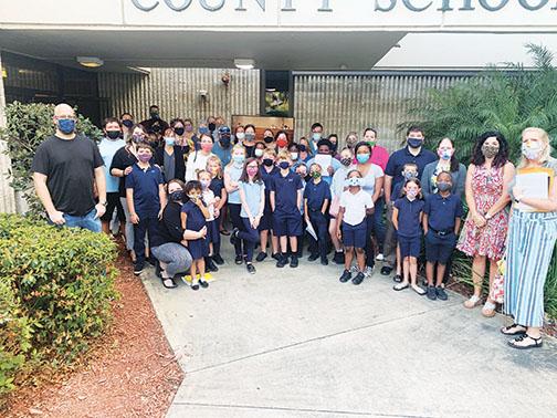 Supporters of the Children’s Reading Center in Palatka gather outside Putnam County School District headquarters for Tuesday’s board meeting.