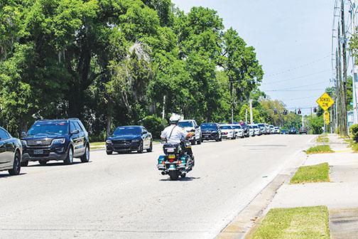 A caravan of law enforcement officers from Putnam and St. Johns counties escort the body of Putnam County Sheriff’s Office Capt. Mark Elam to Johnson-Overturf Funeral Home on Thursday.