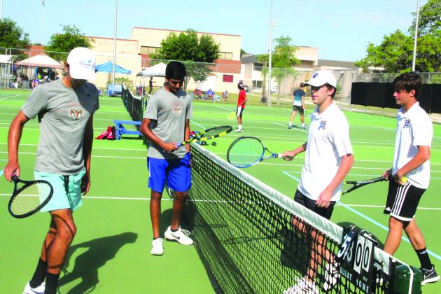 Palatka’s Ian Peters and Richard Bayne of Palatka (at right) meet at the net with Gainesville Eastside’s Viktor Mai and Vedant Karalkar following their second doubles semifinal won by the Eastside pair on Wednesday. (ANTHONY RICHARDS / Palatka Daily News)